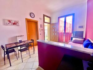 a living room with a table and a dining room at La Casetta Monza Park in Vedano al Lambro