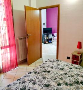 a bedroom with a bed and a wooden door at La Casetta Monza Park in Vedano al Lambro