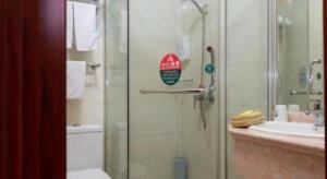 a bathroom with a shower and a toilet and a sink at GreenTree Inn Shanghai South Railway Station Xujiahui Stadium Subway Station Shell Hotel in Shanghai