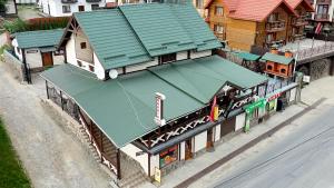 an overhead view of a train station with a green roof at Palaga Bukovel in Bukovel