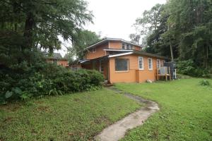 a house with a yard in front of it at King Bed Creekfront Retreat in Jacksonville in Jacksonville