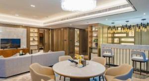 a living room with a couch and a table and chairs at Shunshine International Hotel Xiangxi in Ganziping