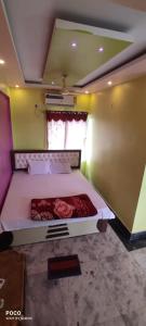 a bedroom with a bed in a room at Maa durga weaver lodge & banquet in Navadwīp