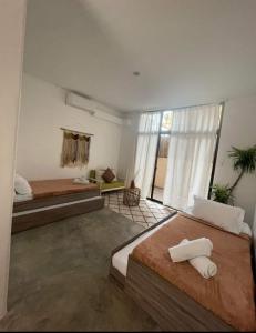 Postel nebo postele na pokoji v ubytování Meraki Siargao Resort + 6 fotografií