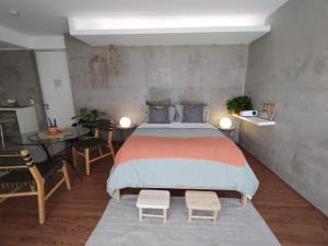a bedroom with a bed and a table and chairs at Cute Condesa Studio Indoor Pool Nice Gym in Mexico City +14 photos