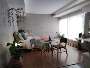 a room with a table and chairs and a bed at Cute Condesa Studio Indoor Pool Nice Gym in Mexico City