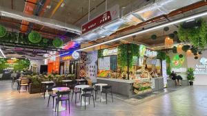 a restaurant with tables and chairs in a building at 118 Island Plaza Tg Tokong Gurney Straits Quay 1BR 1CP Wifi 4pax in George Town