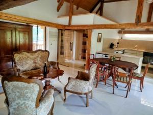 a kitchen and living room with a table and chairs at Jílová tvrz in Rožmberk nad Vltavou