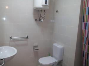 a bathroom with a toilet and a sink at Apartment in Golf Porto Marina in El Alamein +22 photos