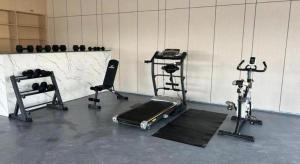 a gym with two exercise bikes and a treadmill at Downtown Hotel in Zhuhai