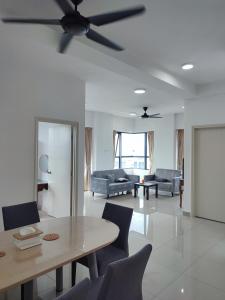 a living room with a table and a ceiling fan at Comfy Room in High Floor! in Kuala Lumpur