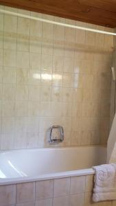 a bathroom with a bath tub with a towel at Ferienwohnung Gadenstatt in Davos +22 photos