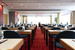 a row of tables and chairs in a restaurant at IntercityHotel Schwerin in Schwerin