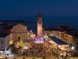 a crowd of people standing in front of a clock tower at Eco-Luxury Suite Luna in Umag