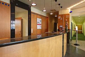 a lobby with a bar in a building at IntercityHotel Schwerin in Schwerin
