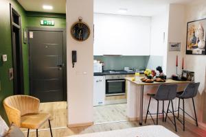 a kitchen with a table and chairs in a room at Studio apartman Navis 2 in Slavonski Brod