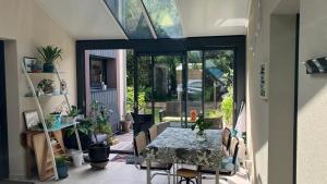 a dining room with a table and some plants at Ker Neizh Cancale, Cottage Baie de Cancale GR34 in Cancale