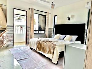 a bedroom with a large bed in a room at Mambo Sea view 3bd Penthouse Mombasa in Mombasa +13 photos