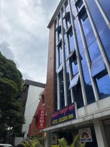 a building with a sign in front of it at HOTEL GOLDEN Inn in Bengaluru +10 photos