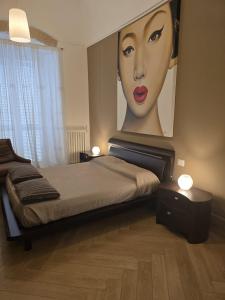 a bedroom with a large painting of a woman at Ancaranvs B&B in Bitonto