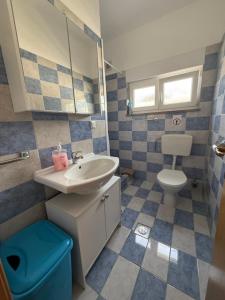 a bathroom with a sink and a toilet and a mirror at Villa Janja in Šilo +133 photos
