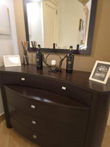 a dresser with a mirror and some bottles on it at Ancaranvs B&B in Bitonto +34 photos