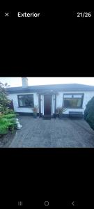 a picture of a house with a bench in a yard at 0ne bed house on private road in Lusk