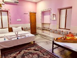 a room with two beds and a sink in it at Mystic View Jodhpur in Jodhpur