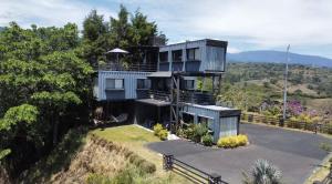 una casa situada en la cima de una colina en cargo containers, en Sarchí