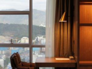 a room with a desk in front of a window at Empark Grand Hotel Fuzhou in Fuzhou