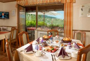 a table with food on it in a dining room at Pension und Weingut Moselblick in Brauneberg