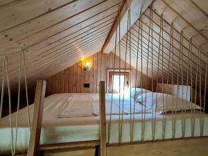 a bedroom with a bed in a wooden room at Echo Magura in Măgura