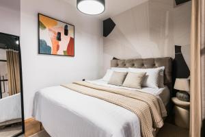 a bedroom with a large bed with white sheets at Calidum Boutique Suites in Šibenik +61 photos