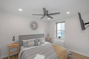 a bedroom with a bed and a ceiling fan at Stayatl Premier 2 Bed Condo W Views! in Atlanta