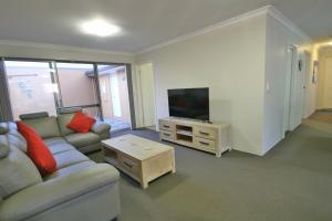 a living room with a couch and a flat screen tv at Marina Sands in Geographe