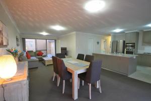 a kitchen and living room with a table and chairs at Marina Sands in Geographe