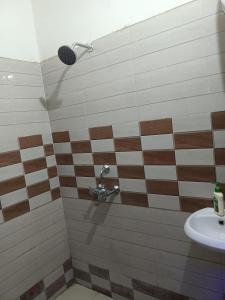 a bathroom with a shower and a sink at May Flower in Patna