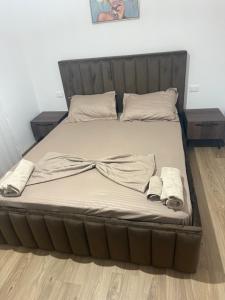 a large bed with a bow on top of it at Residenza Seliano in Velipojë