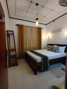 a bedroom with a bed and a ladder in it at Eco Touch Dickwella in Batigama