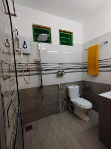 a bathroom with a toilet and a shower and a sink at Eco Touch Dickwella in Batigama +26 photos