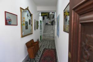 a hallway with a stairway with pictures on the walls at Maison Lepore in Vietri di Potenza