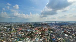 an aerial view of a city with buildings at Palam Mansion at Meisterstadt Pollux Habibie Apartment in Batam Center