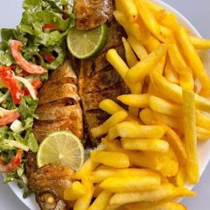 a plate of fish and french fries and a salad at montana restaurant musanze in Ruhengeri +3 photos
