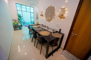 a long dining room with a long table and chairs at 3Bhk Villa with Swimming Pool I Nyra Homestay in Jaipur