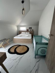 a bedroom with a bed and a rug on the floor at Fintirik Cozy Stay in Stavros