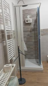 a shower with a glass door in a bathroom at Casa Relax - Relax Holiday in Valledolmo
