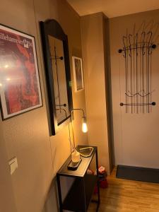 a room with a table with a lamp and a door at Hafjell Alpinlandsby in Hafjell +1 photo