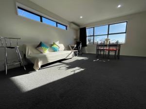 a bedroom with a bed and a large window at Character & new CNZhouse with quiet in Christchurch