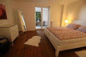a bedroom with a bed and a white rug at Schicke Ferienwohnung für 2 in Niederkalbach