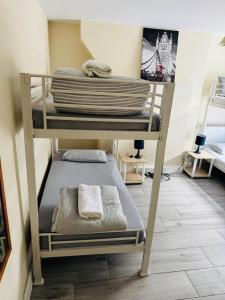 a bunk bed with towels on top of it in a room at APlaceToStay Central London apartment, Zone 1 LEIC in London